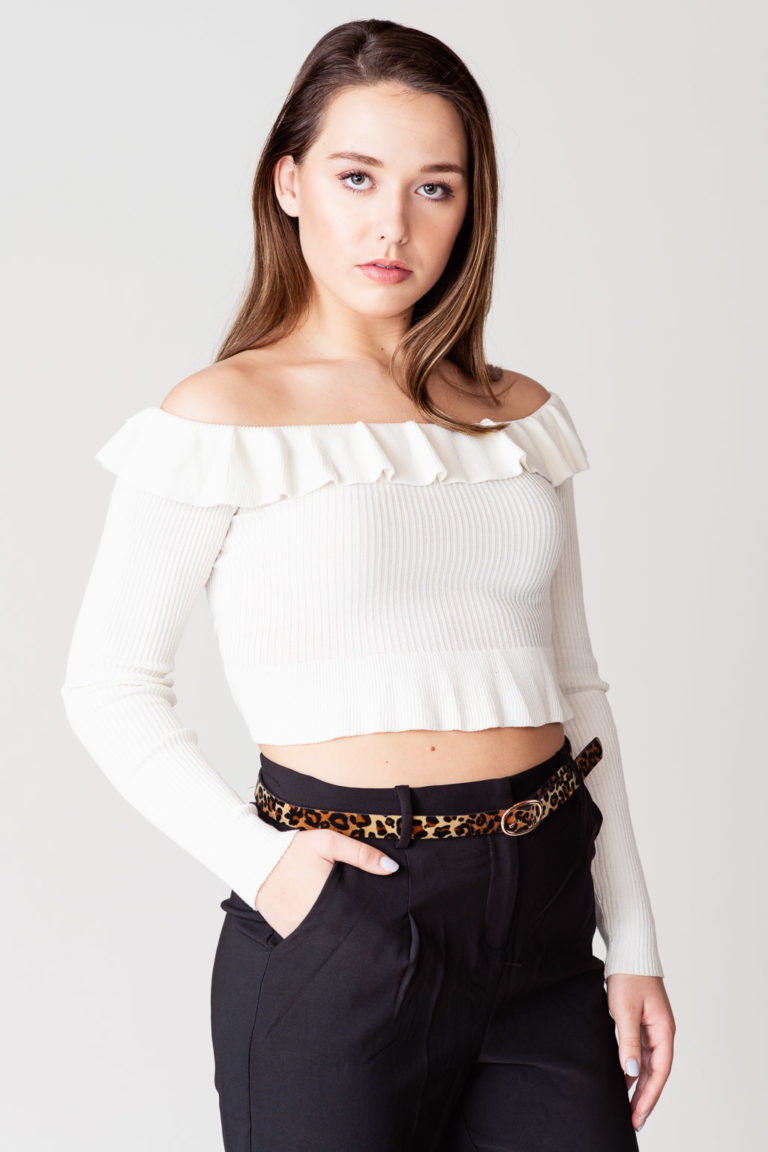Natural light portrait of model in light colored top and dark pant