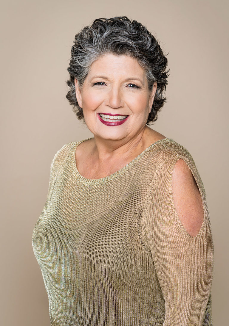 Portrait photography of beautiful mature woman with short hairon neutral background