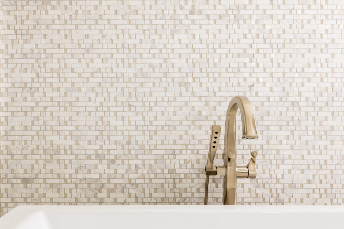 Detail shot of beautful tub faucet in modern remodeled bathroom